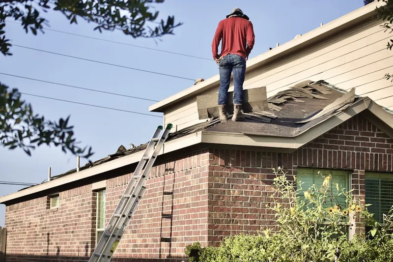 Professional roofer working on a residential roof in Greensview Villas